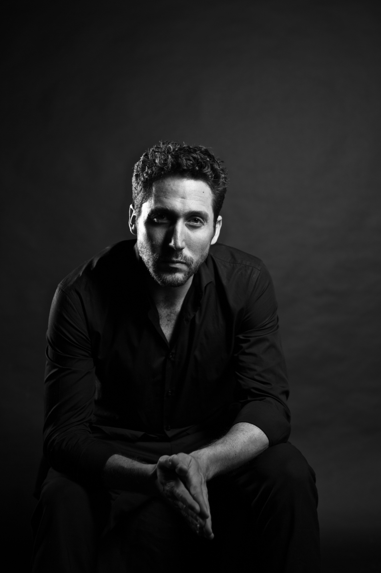 Yshai Afterman, seated, looking at the camera