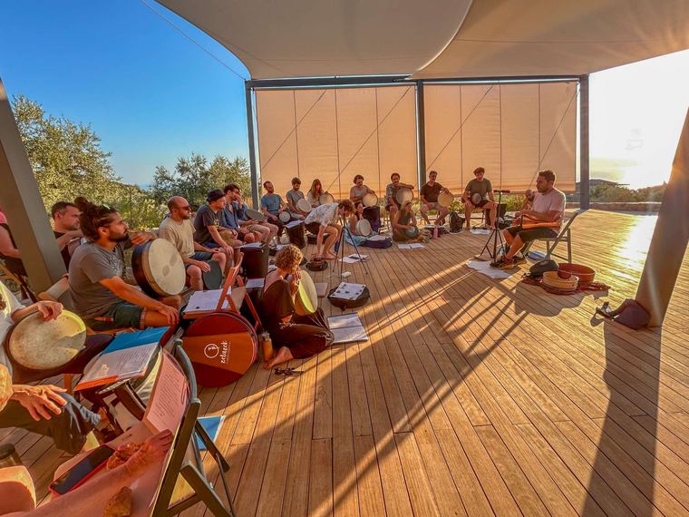 The group playing on the deck in the evening light