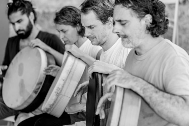 A row of frame drum players
