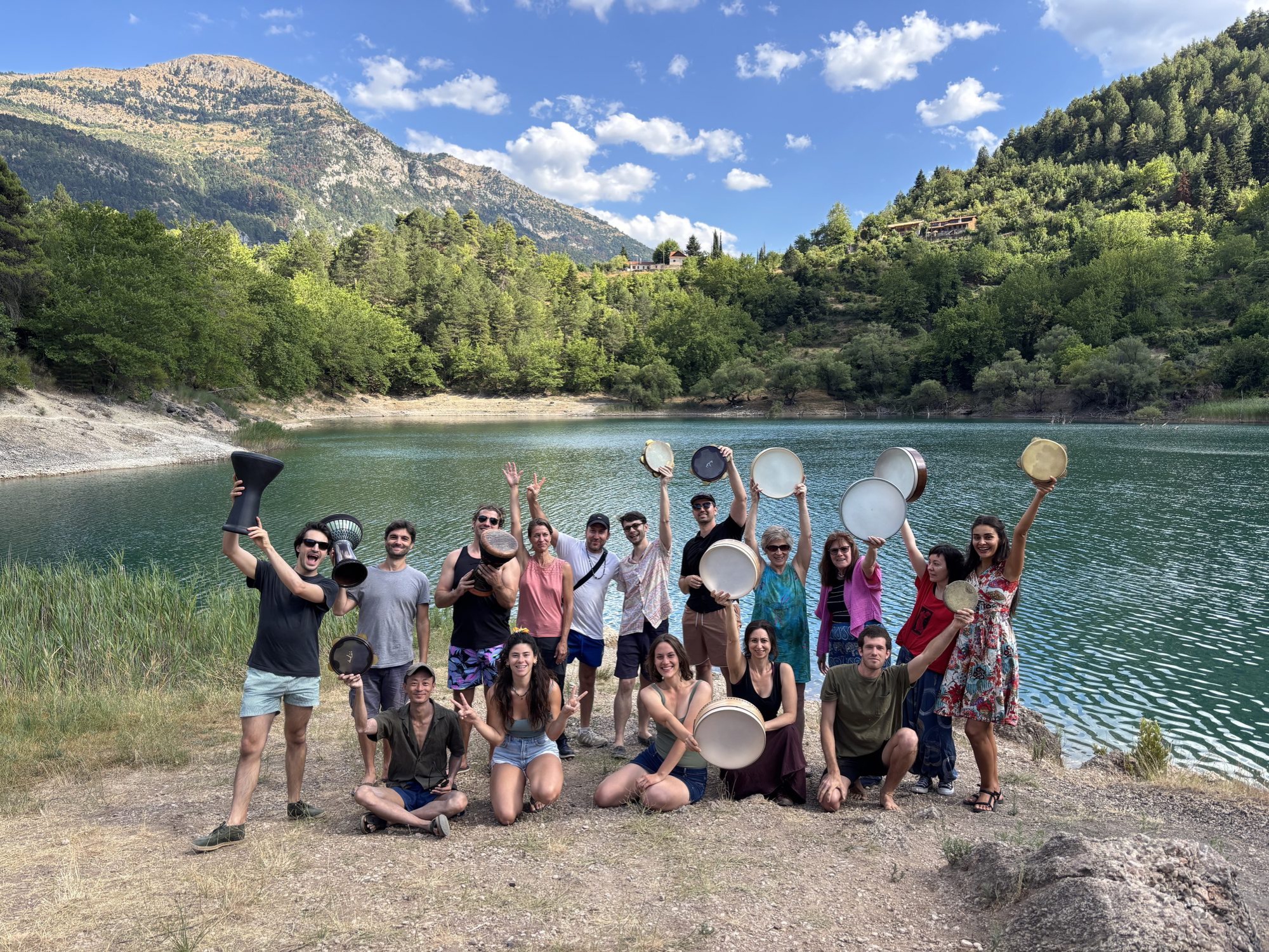 The group by the lake, drums raised