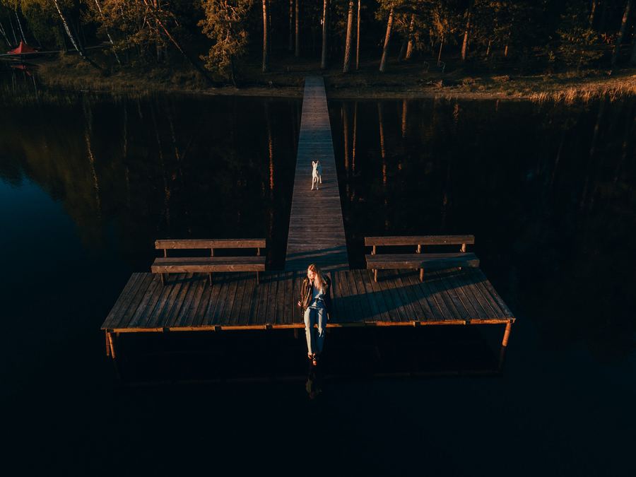 Someone sitting on the lake platform at dusk