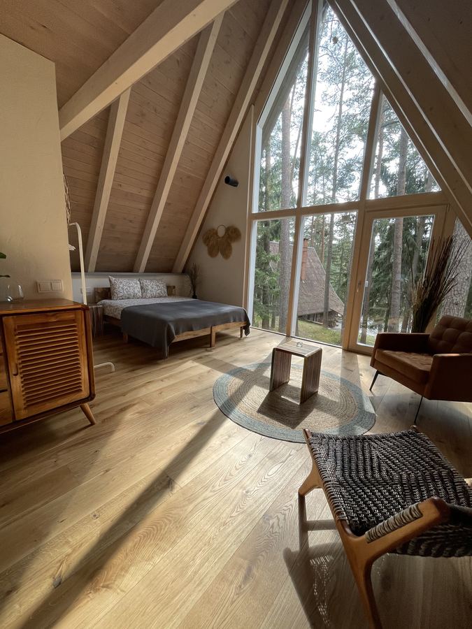 A bright bedroom with tall triangular windows