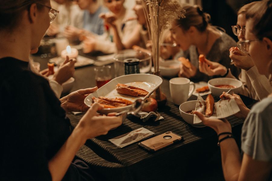 People sharing a meal at a long table